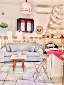 a living room with a couch and a fireplace at Trulli Caroli in Locorotondo