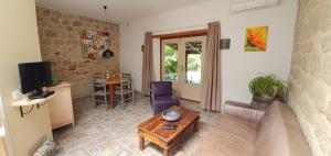 a living room with a couch and a table at Mas Le Corbery in Largentière