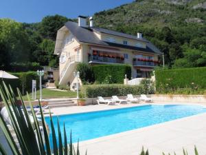 a villa with a swimming pool in front of a house at Villa Casa-Bosta in Ayzac-Ost