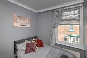 a bedroom with a bed and a large window at Large Parade Coastal House in Hartlepool