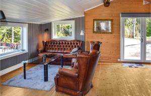 a living room with a couch and a glass table at Nice Home In Heggedal With Wifi And 4 Bedrooms 