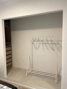 a white closet with a white shirt on a rack at Eksklusiv villalejlighed m/ have 