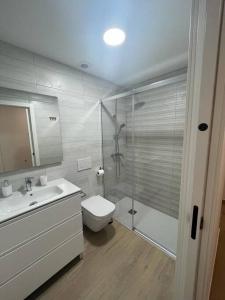 a bathroom with a shower and a toilet and a sink at Apartamento con preciosas vistas a pie de playa in Santa Pola +24 photos