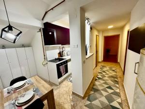 a room with a kitchen and a dining room at Lotus Apartment in Sarajevo