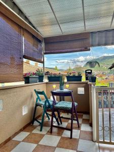 a balcony with two chairs and a table with a view at Lotus Apartment in Sarajevo