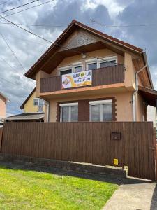 a house with a wooden fence in front of it at Haraplak in Hajdúszoboszló