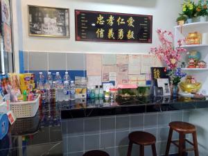 a counter in a restaurant with two stools at Thian Siong Inn in Melaka