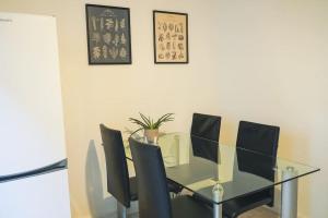 a glass dining room table with black chairs at Nel centro di Locarno vicino a Piazza Grande in Locarno