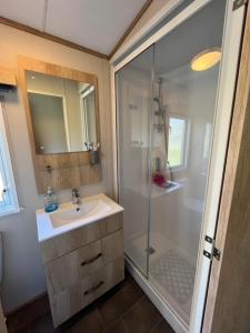 a bathroom with a shower and a sink and a shower at 3 bed luxury lodge at Hoburne Devon Bay in Goodrington