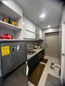 a small kitchen with a sink and a refrigerator at Victoria Sports Tawer in Manila
