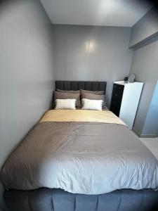 ein Schlafzimmer mit einem großen Bett in einem Zimmer in der Unterkunft Victoria Sports Tawer in Manila