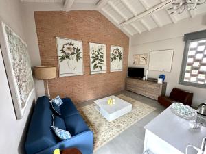 a living room with a blue couch and a table at Podere Milla in Montale