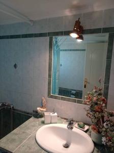 y baño con lavabo y espejo. en George Geust House en Oropós