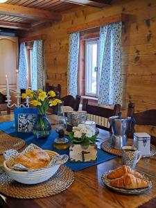 a table with a blue table cloth and food on it at Chalupa Lichtenberg/ Světlík in Horní Podluží