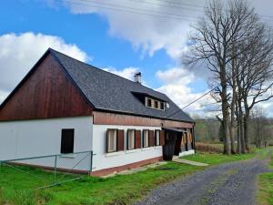 a large white barn with a black roof at Chalupa Lichtenberg/ Světlík in Horní Podluží