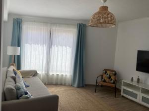 a living room with a couch in front of a window at Casa da Amoreira in Odeceixe
