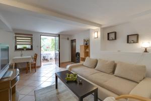a living room with a couch and a table at Apartments Dado in Poreč