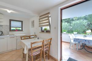 a kitchen and dining room with a table and chairs at Apartments Dado in Poreč