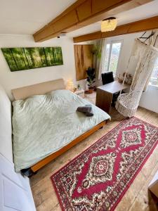 a bedroom with a bed and a hammock and a desk at Private Room in an old Farmhouse near Vaduz in Sevelen