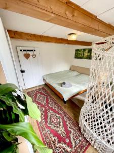 a room with a bed and a hammock at Private Room in an old Farmhouse near Vaduz in Sevelen