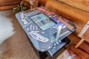a table with a pinball game on top of it at Royal Views - Private Mountain Top Cabin cabin in Gatlinburg