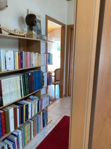 a book shelf filled with lots of books at B&B Mon Rêve, Petit déjeuner BIO, Jacuzzi in Les Evouettes 