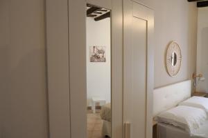 a bedroom with a bed and a mirror at Alla Scaletta in Trapani