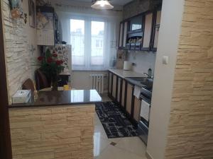 a kitchen with a sink and a stove top oven at Topolowa 13 in Mińsk Mazowiecki