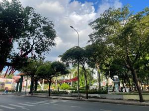 a street light on the side of a street with trees at Camelia 108 Le Lai Hotel in Ho Chi Minh City