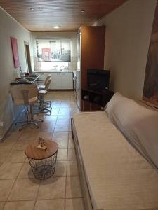 a bedroom with a bed and a desk and a kitchen at Ventus in Afionas