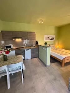 a kitchen with a bed and a table in a room at APARTMA JURICICH in Portorož