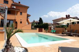 a swimming pool in front of a house at APARTMA JURICICH in Portorož