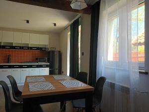 a kitchen with a table and chairs and a window at Sielski Zakątek in Srokowo +5 photos