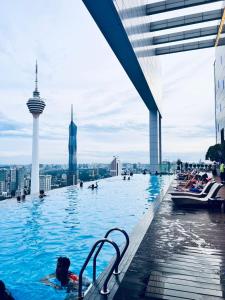 a pool on top of a building with people in it at Platinum Suites KLCC in Kuala Lumpur