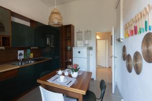a kitchen with a wooden table and a kitchen with a refrigerator at Farina 14 in Florence