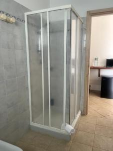 a shower in a bathroom with a glass door at La Striscia Larga in San Pasquale