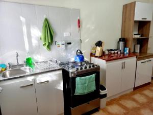 Il comprend une cuisine équipée d'une cuisinière et d'un évier. dans l'établissement hostal casa talitha, à San Pedro de Atacama