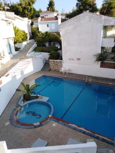 a large blue swimming pool next to a building at Siviri kassandras Xalkidiki, Experience Accomodation in Siviri