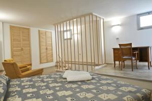 1 dormitorio con cama, escritorio y silla en Vico Cialdini, en Salice Salentino
