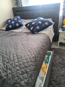 a bed with blue pillows on top of it at Apartament Przy Starym Mieście in Szczecin