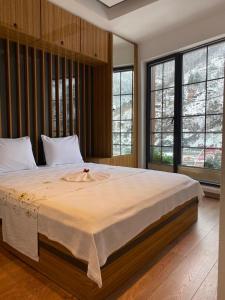 1 cama grande en un dormitorio con ventanas en BLACKLAKE OTEL, en Yeniyol