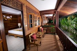 a hotel room with a bed and a balcony at Smile House - Fisherman Village in Bophut