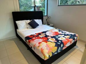 a bed with a colorful quilt on it in a bedroom at Lovely 3 Bedroom Condo with Pool in Darwin