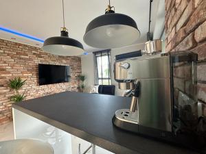 a kitchen with a coffee machine on a counter at Apartament Centrum II in Bydgoszcz