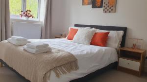 a bedroom with a bed with towels on it at Cozy Bedroom with Garden View in Newcastle under Lyme