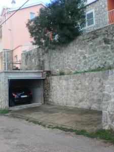 a car is driving into a stone tunnel at Villa Teodora in Donja Vrućica