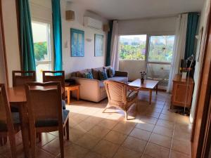 a living room with a couch and a table at BenalSun 100 meters from Beach in Benalmádena