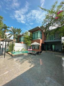 a large building with a patio in front of it at Aonang nine poolvilla in Ao Nang Beach