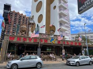 two silver cars parked in front of a restaurant at Ducado 41 Playa in Benidorm