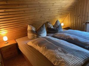 a bedroom with two beds in a wooden wall at Ferienhaus Eichler in Bad Gottleuba